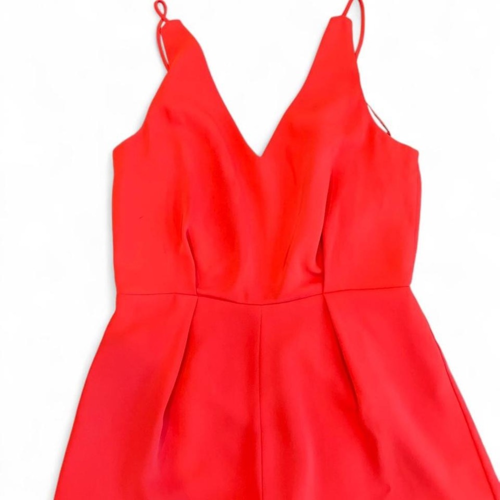 Top Shop red romper featuring a sleeveless design and a flattering V-neckline